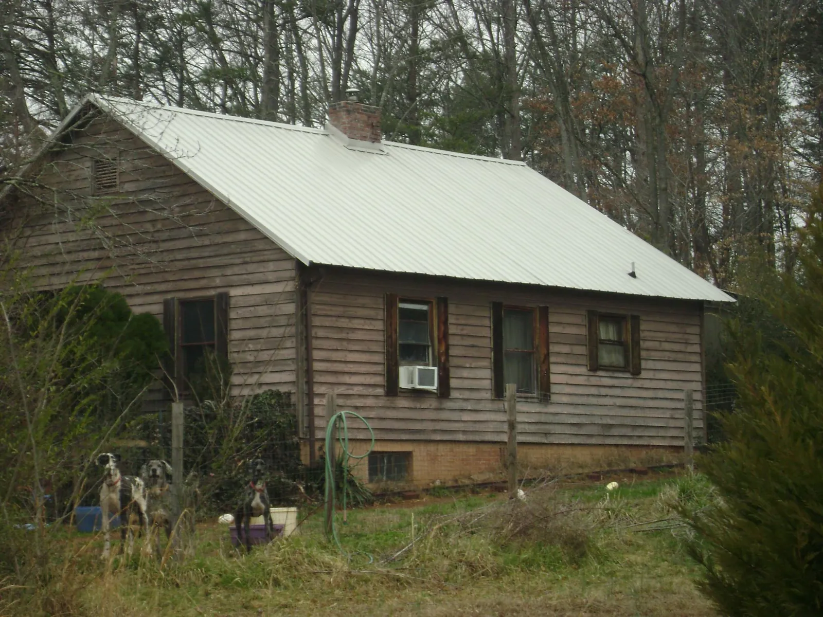 White metal roof on an old wood sided farmhouse, from a Metal Roof Installation job in Kankakee